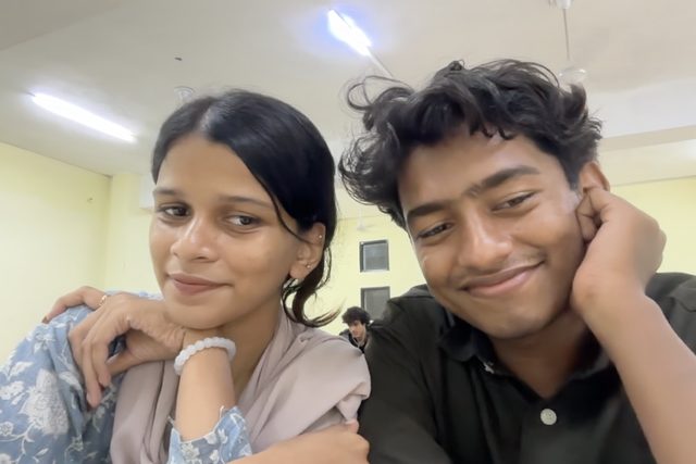 A playful selfie with two friends leaning together.