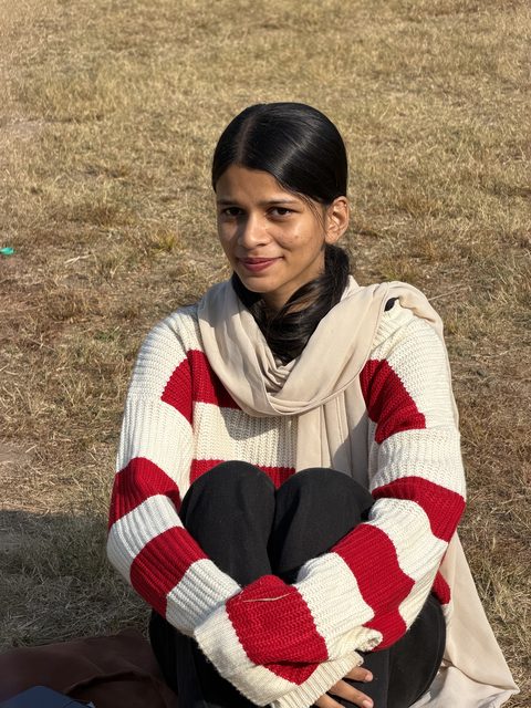 An outdoor portrait in a red-and-white striped sweater.