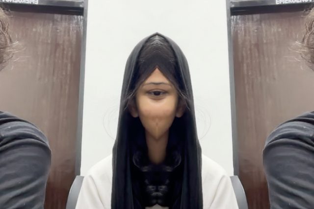 A playful portrait with a scarf pulled around the face.