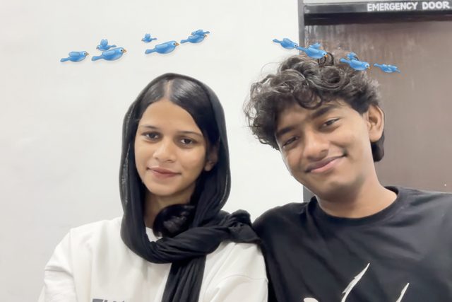 Two friends smiling in a photo-booth frame with a playful sky effect.