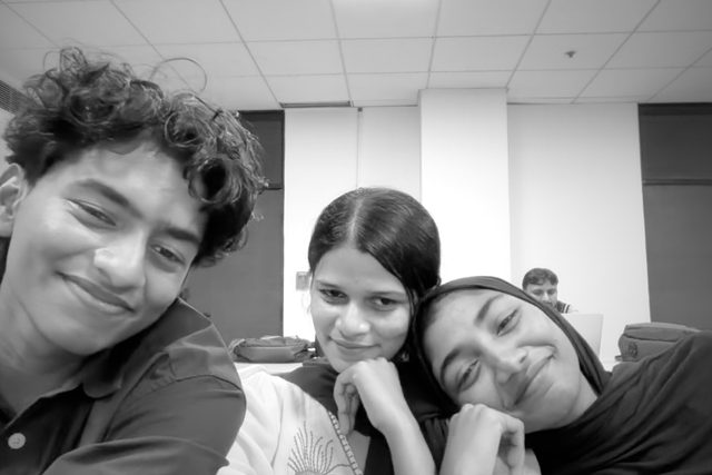 A black-and-white group selfie with playful poses.
